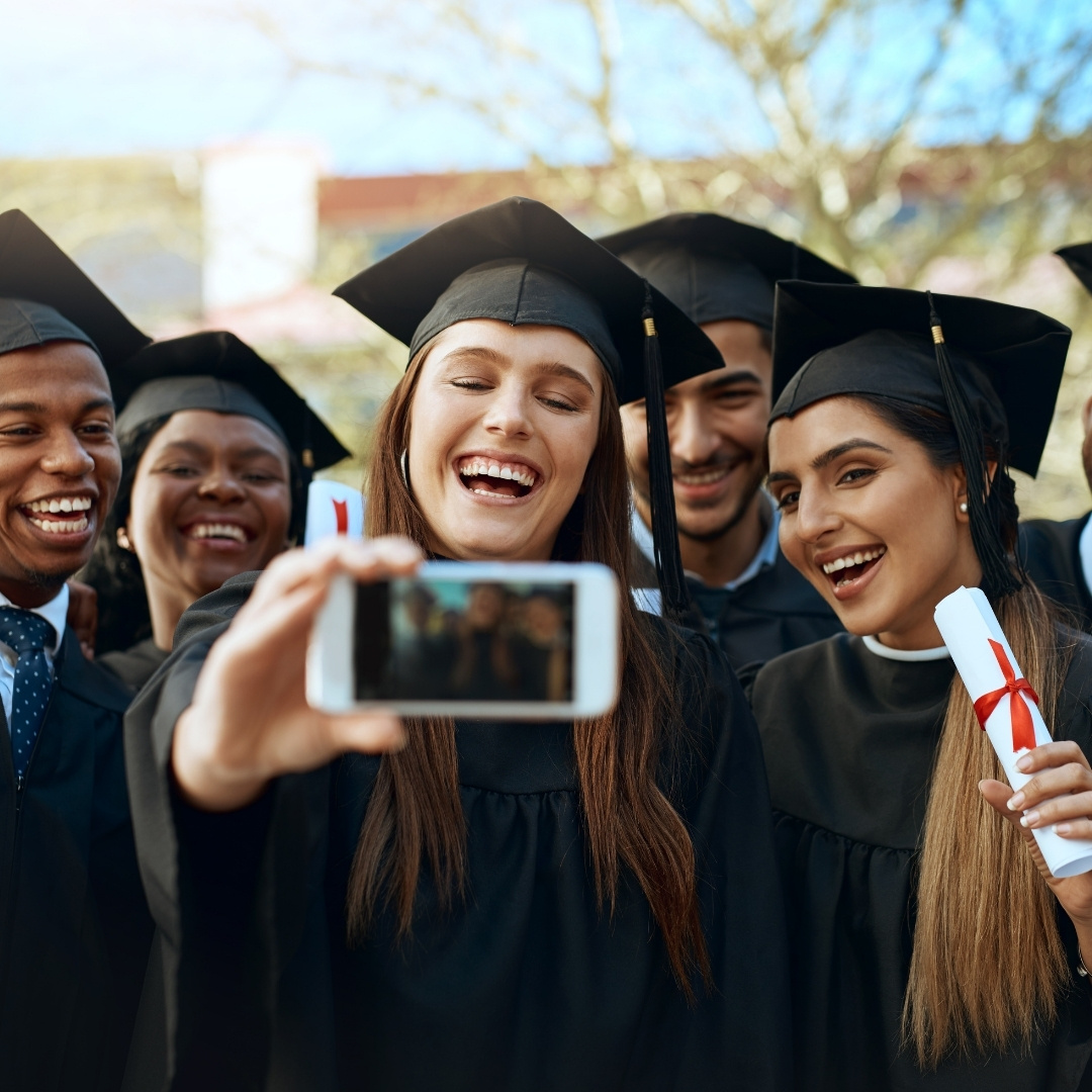 Graduate hugging woman
